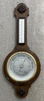 A large vintage dark wood Shortland Smiths banjo barometer with thermometer. Carved applied panels