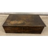An antique dark wood box with scalloped edges, approx. 15cm tall x 57cm long.