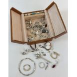 A vintage leather jewellery box containing a mixed collection of scrap silver and gold jewellery.