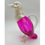 A modern silver plated and pink coloured glass decanter modelled as a duck. Hinged head lid, one