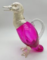 A modern silver plated and pink coloured glass decanter modelled as a duck. Hinged head lid, one