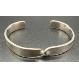 A twist design silver cuff bangle with silver marks to inside. Total weight approx 20.7g.
