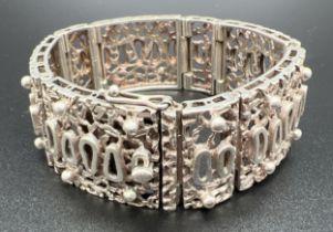 A vintage 7 inch 8 panel bracelet with pierced work abstract design. Push clasp with safety clip.