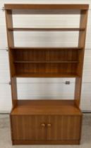 A mid century teak wall unit with 2 door cupboard, possibly Stag. With wooden knob handles and 3