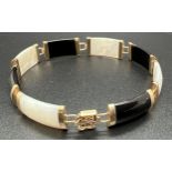 A 9ct gold 8 panel onyx and mother of pearl bracelet with push clasp and safety clip. Chinese