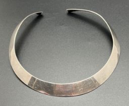 A modern silver torque style necklace. Silver marks to under side. Band width approx. 1.25cm at