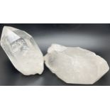 2 large clear quartz points with natural galaxy formations, one with a small cluster to one side.