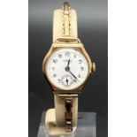 A vintage ladies 9ct gold cocktail watch with expanding bracelet strap by Hirco. White enameled face