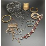 A collection of vintage costume jewellery. To include brass and copper cuff bangles, beaded choker