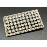 An Art Deco square shaped silver brooch set with marcasite and clear stones. Marked 935 to back.