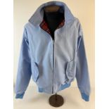 A men's classic Harrington jacket in light blue, in as new condition. With red tartan lining,