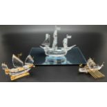 3 boxed Swarovski ships and galleons. A Crystal Memories crystal and gold plated Viking longboat,