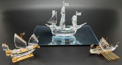 3 boxed Swarovski ships and galleons. A Crystal Memories crystal and gold plated Viking longboat,
