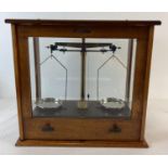 A set of Griffin & george microid chemist scales, in a Philip Harris & Co (1913) glass panelled