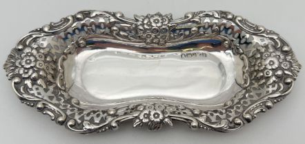 An Edwardian silver pin dish/card tray with decorative floral & scroll design rim with pierced