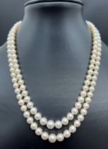 A vintage cream cultured pearl double row necklace with 14ct white gold clasp set with pearls and