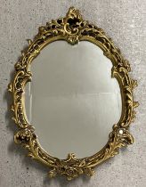A vintage Rococo style wall hanging hall mirror with gold painted chalk frame of scroll & foliate