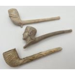 3 antique white clay pipes. All with carved detail. To include a carved head of a woman (a/f) and