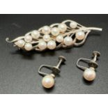 A vintage white metal and cultured pearl leaf shaped brooch with a pair of white metal single