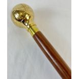 A modern wooden walking cane with spherical brass finial modelled as a globe. Approx. 94cm long.
