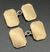 A vintage pair of 9ct gold and silver cufflinks with engine turned decoration to fronts. Backs