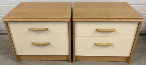 A pair of vintage Stag 2 drawer bedside cabinets in light natural wood and cream coloured finish.
