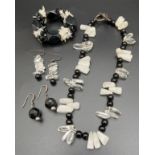 A modern design onyx, clear and opaque rock crystal necklace with silver T Bar clasp. Together