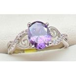 A rhodium plated cocktail ring set with Swarovski crystals, new with tags. Central purple oval cut