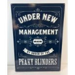 A large Peaky Blinders printed tin sign. With holes for wall fixing. Approx. 70cm x 50cm.
