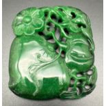 A carved Chinese jade roundel modelled as pumpkins/gourds. With carved detail to both sides. Approx.