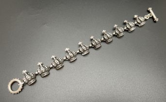 A heavy 925 sterling silver crown and cross design panel bracelet in the style of Vivienne Westwood.