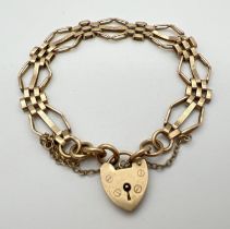 A 9ct gold vintage 3 bar gate style bracelet with padlock clasp and safety chain. Gold marks to back