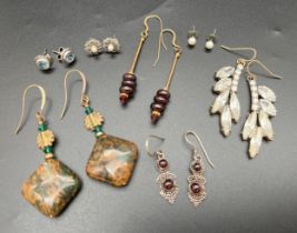 A collection of assorted vintage earrings to include precious metals and gemstones. Lot includes