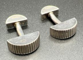 A pair of Tiffany & Co. semi circular shaped cuff links with coin edge detail. Makers marks and