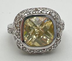 A silver, lemon quartz and cubic zirconia cocktail ring with central cushion cut stone. Surrounded