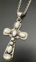 An Arts & Crafts style large silver cross shaped pendant on an 18" silver twisted rope chain.
