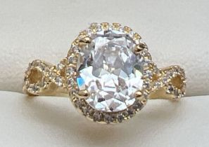A 14ct gold plated cocktail ring set with Swarovski crystals, new with tags. Halo set central oval