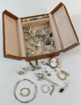 A vintage leather jewellery box containing a mixed collection of scrap silver and gold jewellery.