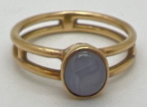 A bespoke made Macintosh style double band yellow metal dress ring with a bezel set oval grey