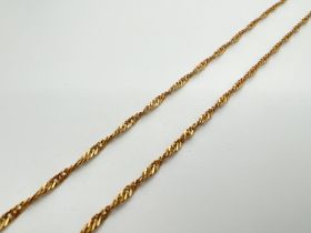 A 28 inch 18ct gold Singapore style chain necklace with Spring ring clasp. Worn marks to clasp.