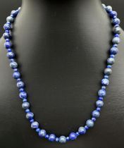 A 18" lapis lazuli beaded necklace with silver tone T bar clasp. Largest lapis beads approx. 7mm