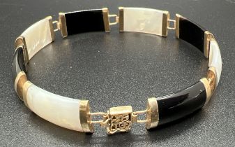 A 9ct gold 8 panel onyx and mother of pearl bracelet with push clasp and safety clip. Chinese