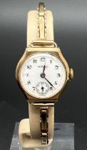 A vintage ladies 9ct gold cocktail watch with expanding bracelet strap by Hirco. White enameled face
