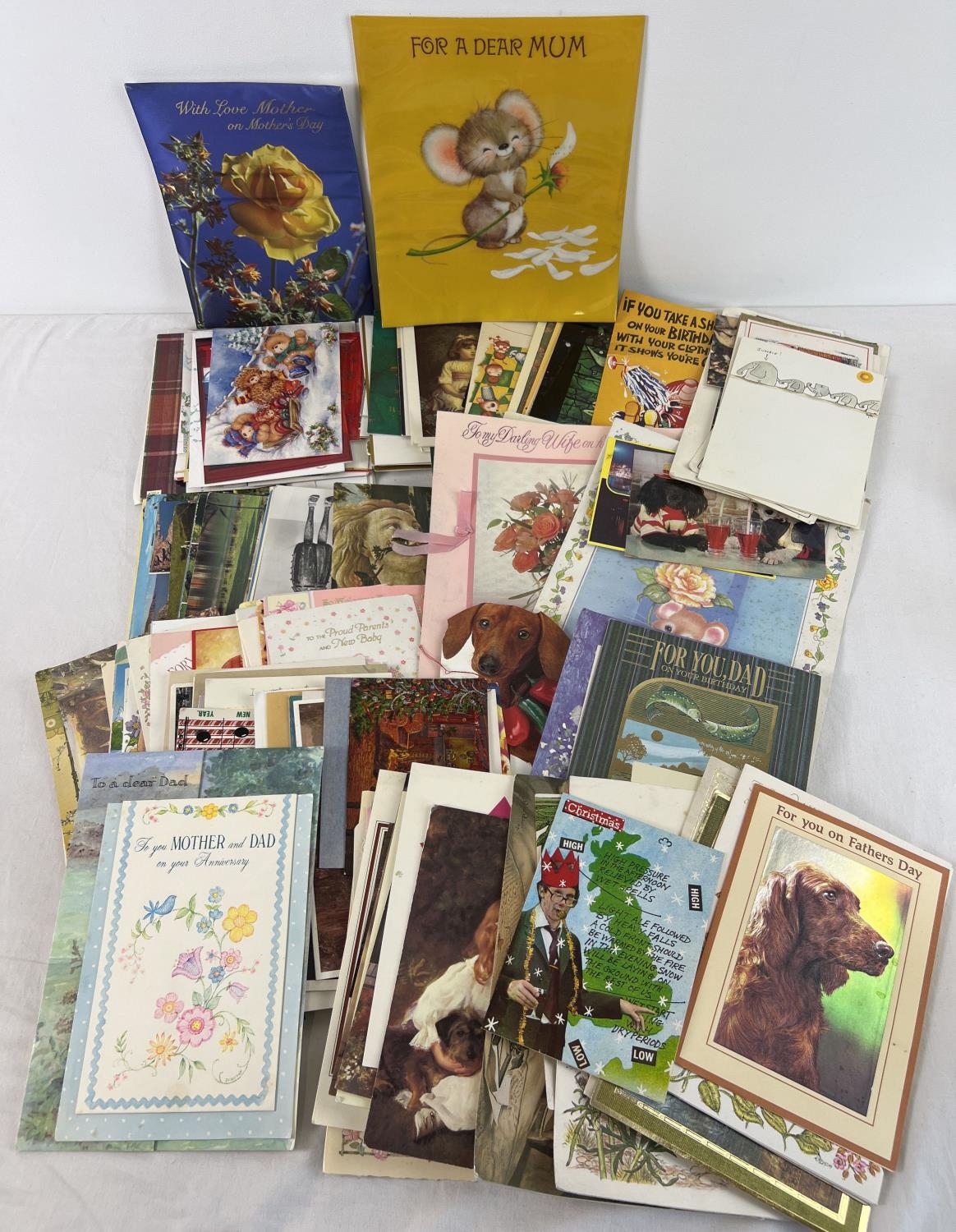 A box of assorted vintage & more modern postcards and greetings cards.