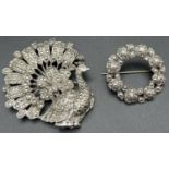 2 vintage brooches both set with marcasite stones. A silver circular rose detail brooch marked "Sil"