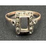A vintage 9ct gold and silver dress ring. Square set mount with central stone missing, with 14 small