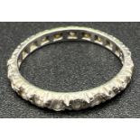 A vintage 9ct white gold full eternity ring set with small round cut clear stones. Gold mark