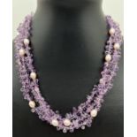 A cased 16" amethyst and pink lustre multi strand necklace with 14ct gold fish hook clasp.
