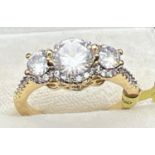 A 14ct gold plated cocktail trilogy ring set with Swarovski crystals, new with tags. 3 round cut