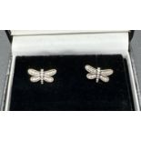A pair of silver and clear stone set dragonfly stud earrings by Pandora. Edge of earrings marked